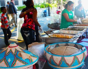 The Ohter family members greet each other as they get prepared to serve an Eritrean Sampler plate. The sampler included beef stew, Enjera bread, and has a vegetarian alternative.