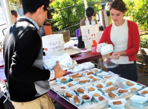 Chloe Nicolaus prepares canolis for a customer. Her Greek family also had Gelato and Namoura at there booth. Namoura is a dessert cake made with semolina butter and coconut topped with a fragrant sugar based syrup.  