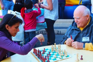 Church member Eugene Uchalies teaches Carmen Espinoza a thing or two about chess. 
